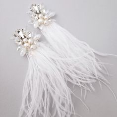 two pieces of white feathers with pearls on them