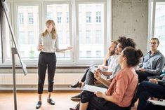 a woman standing in front of a group of people