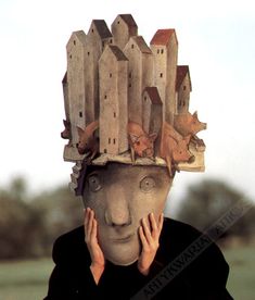 a person wearing a mask with animals on it's head