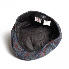 Introducing the Dasmarca Justin Scottish Harris Tweed Winter Cap, a pinnacle of warmth and style for the colder seasons. Crafted with renowned Harris Tweed from Scotland and meticulously constructed in Italy, this cap epitomizes quality and sophistication. Made from 100% virgin wool, it offers supreme insulation against chilly temperatures. Inside, a quilted lining ensures extra warmth and comfort, making it ideal for frosty days. Authenticated with the Dasmarca metal pin, this cap guarantees authenticity and superior craftsmanship. Elevate your winter ensemble with the timeless elegance and unmatched warmth of the Dasmarca Justin Scottish Harris Tweed Winter Cap This cap is designed to develop character and age gracefully over time. It is not recommended for hand or machine washing. If th Classic Tweed Hats For Outdoor, Blue Flat Cap For Fall, Winter Outdoor Beret Flat Cap, Classic Navy Wool Hat, Wool Visor Hat For Winter, Winter Tweed Hat With Herringbone Pattern, Winter Hats With Herringbone Pattern And Curved Brim, Winter Wool Visor Hat, Tweed Winter Cap