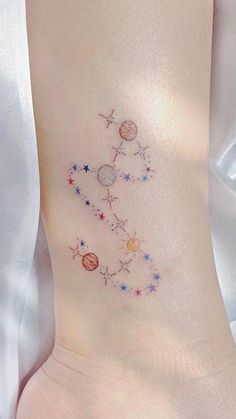 a woman's foot with stars and planets on it