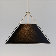 a black and gold lamp hanging from a ceiling fixture with a brown shade on it