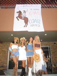 three beautiful women standing next to each other in front of a sign that says, it's going coast coast for mc2