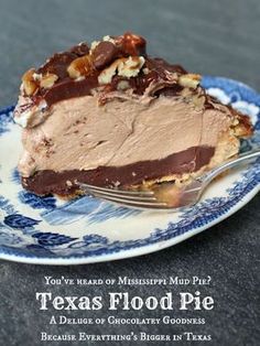 a piece of pie on a blue and white plate with a fork in front of it that says, you've heard of mississippi mud pie? texas flood pie