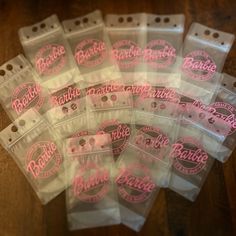 some plastic bags with pink lettering on them