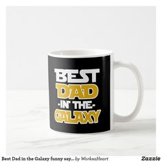 a black and white coffee mug with the words best dad in the galaxy on it