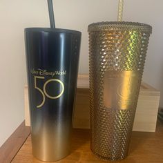 two tumblers sitting next to each other on a table