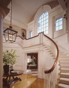 a staircase in a house with white walls and wood floors