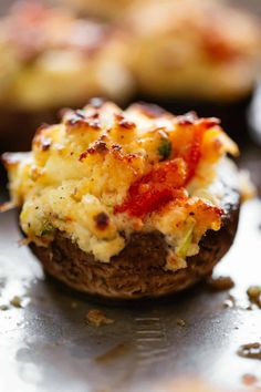 an eggplant and cheese muffin on a baking sheet with other muffins in the background