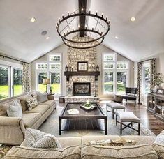 a living room filled with lots of furniture and a fire place in the middle of it