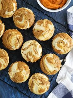 several cupcakes on a cooling rack next to a bowl of sweet potato dip