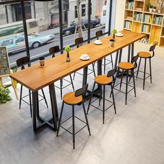 a long table with four chairs in front of it