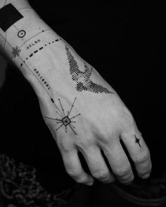 a person's hand with a tattoo on it and an arrow in the middle