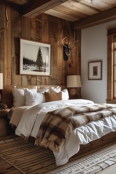 a bed sitting in a bedroom next to a window with deer heads on the wall