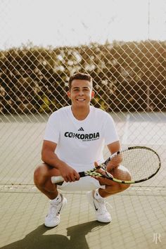 a man kneeling down holding a tennis racquet