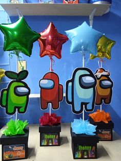 there are many balloons and decorations on the shelf in front of this display, which is decorated with different colors