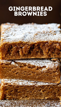 three pieces of gingerbread brownies stacked on top of each other with powdered sugar