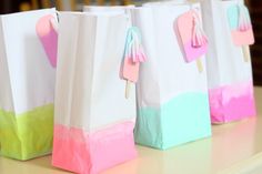 some paper bags with tassels on them sitting on a table