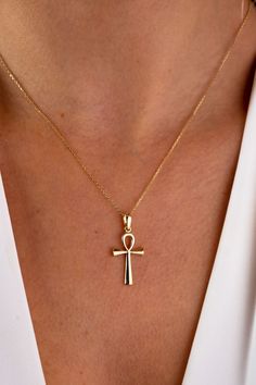 "This 14K gold cross necklace is a beautiful and meaningful piece of jewelry that would make a perfect gift for any occasion. The crucifix pendant is a symbol of faith and devotion, and would be a thoughtful present for a loved one on Christmas, Father's Day, Mother's Day, Valentine's Day, an anniversary, or a birthday. The necklace features a small and dainty cross charm that hangs from a delicate chain, making it perfect for those who prefer a more subtle and discreet look. It would be a suita Symbolic Yellow Gold Cross Jewelry, Symbolic Yellow Gold Cross Necklace, Spiritual Cross Necklace In Yellow Gold, Spiritual 14k Gold Cross Pendant Necklace, 14k Gold Spiritual Cross Pendant Necklace, Spiritual Yellow Gold Cross Necklaces, Symbolic Crucifix Cross Necklace As Gift, 14k Gold Cross Necklace For Spiritual Wear, Gold Symbolic Crucifix Jewelry And Charms