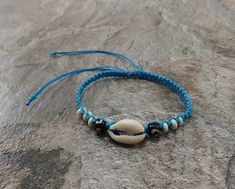 Cowrie Shell Bracelet - Blue Color Adjustable Bracelet - Unisex Handmade Design with Waxed Hemp Cord for Durability Adjustable Cord - Fits Most Size Bracelet Fits most Size / Anklet (It can be use as an anklet but small feet Approx. up to size 7 shoes in women. FAST SHIPPING! *First Class Mail* Blue Beaded Braided Bracelets For Vacation, Casual Adjustable Shell Beaded Bracelets, Adjustable Beaded Shell Bracelet, Blue Strand Jewelry For Friendship, Blue Hand-strung Braided Bracelets For Beach, Blue Beaded Bracelet With Sliding Knot For Vacation, Blue Beaded Bracelets With Sliding Knot For Vacation, Blue Shell Beaded Bohemian Bracelet, Blue Shell Beaded Bracelet As Gift