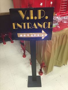 a sign that says v i p entrance with an arrow pointing to the right and lights on it