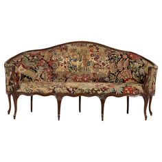 an ornately decorated couch with wooden legs