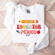 Please note that our Christmas deadline is December 5. Orders placed after that may not arrive on time, and we are not responsible for late arrivals due to carrier delays. **Delivery times in Etsy are an estimate. Due to carrier fluctuations we cannot make delivery date guarantees - please plan accordingly Celebrate your teaching journey with our "In My Educator Period" sweatshirt. Perfect for showing your educator pride, this cozy sweatshirt makes a great gift for teachers. Ideal for back to school or any occasion to highlight your dedication to education. Stay warm and stylish while inspiring your students. Product Features: Fabrication: Medium-heavy fabric (8.0 oz/yd² (271.25 g/m 50% cotton, 50% polyester Seams: Without side seams Fit: Loose fit Sizing: Unisex Sizing Label: Sewn-in labe Clothing Board, Back To School Outfit, Teacher Sweatshirt, Great Teacher Gifts, Teacher Appreciation Gift, Back To School Outfits, Cozy Sweatshirts, Graphic Shirt, School Outfit