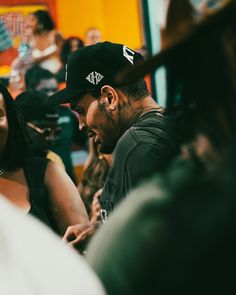 a man and woman sitting next to each other in front of a group of people