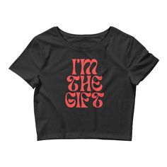 "Elevate your style game with this must-have \"I'm The Gift\" Crop Top! Made from a premium blend of 52% combed ring-spun cotton and 48% polyester, this top is designed to provide a comfortable and stylish fit. The 40 singles fabric weight of 3.6 oz/yd² (122 g/m²) and slim fit design with side-seam construction make this top a versatile addition to your wardrobe. Available in black or white, this crop top is sourced from Nicaragua, the US, or Honduras and is made to order, helping reduce overpro Trendy Black T-shirt For Gift, Black Fitted Top As A Gift, Black Fitted Top For Gift, Black Letter Print Top As A Gift, Black Tops With Letter Print For Gift, Black Graphic Print Top For Gift, Black Letter Print Top As Gift, Graphic Print Black Top As Gift, Black Graphic Print Top As Gift