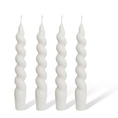 three white candles are lined up next to each other