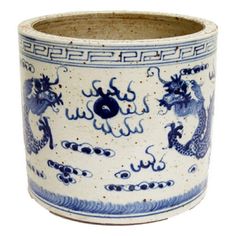 a blue and white vase with dragon designs on it