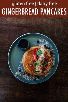 a blue plate topped with pancakes covered in powdered sugar