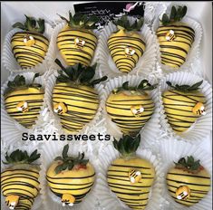 chocolate covered strawberries with yellow stripes and green leaves