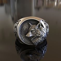 Embrace the captivating allure of the wild with our Wolf and Moon Ring, exquisitely handcrafted from 925 Sterling Silver. This enchanting piece harmonizes the mysterious beauty of the moon with the untamed spirit of the wolf, making it an excellent accessory for nature lovers, romantics, and lovers of unique jewelry. Our Wolf and Moon Ring showcases a beautifully sculpted wolf silhouette against the backdrop of a textured moon. This awe-inspiring design is intricately rendered in high-quality st Wolf And Moon, Wolf Ring, Viking Ring, Silver Wolf, Masonic Ring, Retro Ring, Wolf Moon, Moon Ring, Wolf Head