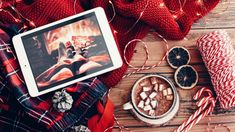 a tablet computer sitting on top of a wooden table next to candy canes and peppermin