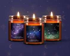 three candles with the zodiac signs on them and stars in the sky behind them, all lit up