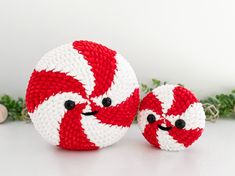 two red and white balls sitting next to each other