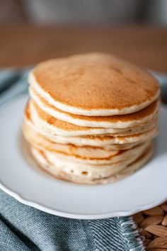 a stack of pancakes sitting on top of a white plate