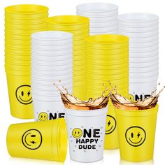 yellow cups with smiley faces and one happy dude on them are stacked in front of each other