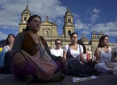 a group of people sitting on the ground doing yoga