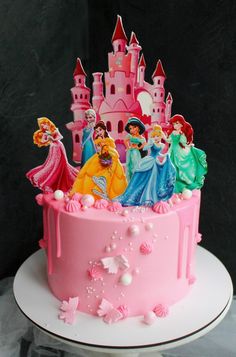 there is a pink cake with princesses on it