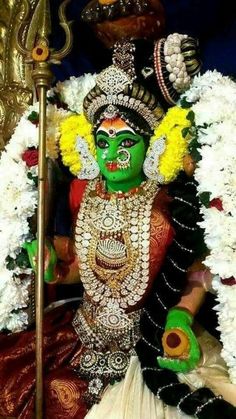 an idol is shown with flowers around it