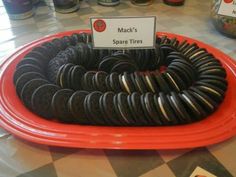 there are many black and white cookies on the red plate with a sign that says mack's spare tires