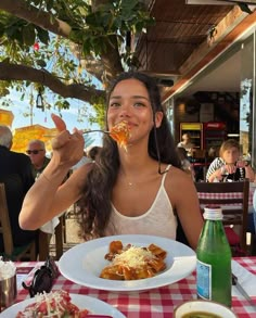 a woman sitting at a table eating food