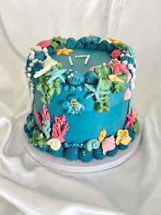 there is a blue cake decorated with sea creatures