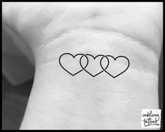 three hearts tattoo on the wrist