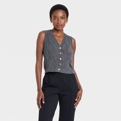 This Cabled Button-Down Vest from A New Day™ adds a stylish staple to your cool-weather wardrobe. Designed in a classic cable-knit pattern in a solid shade with ribbed edges, this sleeveless cardigan is made from a lightweight fabric blend for comfortable wear. It's tailored in a casual fit with a mid-length silhouette and features a flattering V-neck and a full-length button-down placket that can be worn buttoned or unbuttoned. A New Day™: Style that goes wherever you do. Womens Tailored Suit, Vest Womens, Sleeveless Cardigan, Suit Vest, Down Vest, Hem Style, Tailored Suits, Knit Pattern, Casual Fit