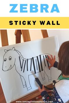 a young child is painting a zebra on a canvas with the words zebra sticky wall