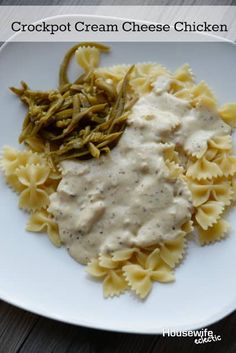 crockpot cream cheese chicken pasta on a white plate with green beans and gravy