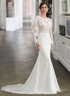 a woman in a white wedding dress posing for the camera